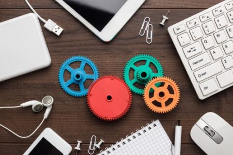 workflow and teamwork concepts with colorful gears and different gadgets